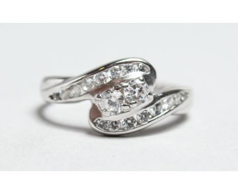 A 9CT WHITE GOLD ZIRCON TWIST RING.