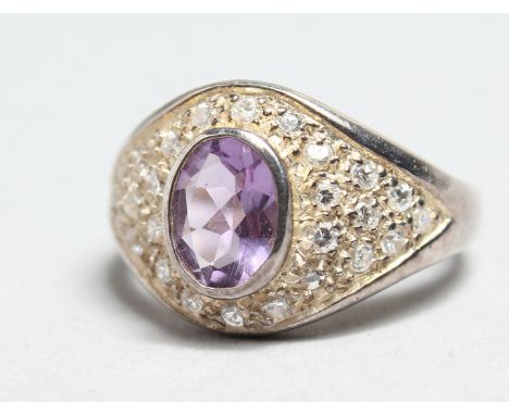 A SILVER AMETHYST AND CZ RING.