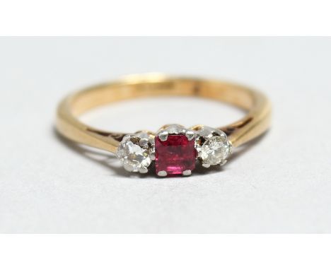 AN 18CT GOLD, RUBY AND DIAMOND THREE STONE RING.