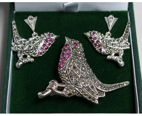 A SILVER MARCASITE AND RUBY BIRD BROOCH AND A PAIR OF EARRINGS