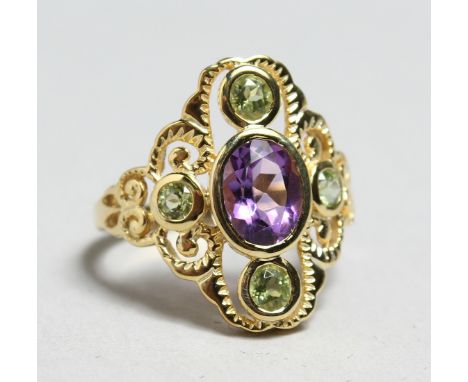 A SILVER PLATED PERIDOT AND AMETHYST RING.