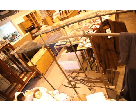 Pair of painted steel shop clothing racks with glass shelf tops and four matching wall rails, L: 180 cm, H: 120 cm. Not avail
