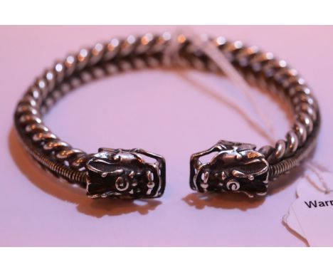 White metal Tibetan silver twisted bangle with dragon head terminals. P&amp;P Group 1 (£14+VAT for the first lot and £1+VAT f
