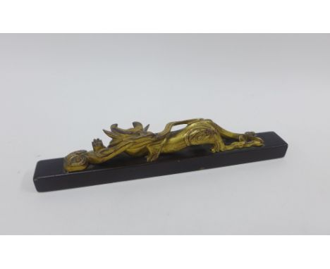 Chinese gilt and lacquered scroll weight with dragon, 24cm long 
