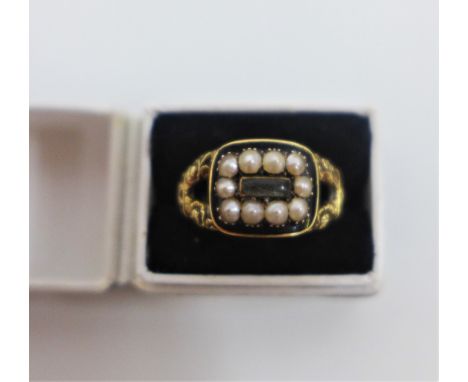 Georgian yellow metal mourning ring with hair compartment within a surround of seed pearls and black enamel, with foliate pat