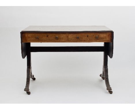 A Regency rosewood and satinwood banded sofa table, fitted two drawers on end standards, the reeded outswept legs with brass 