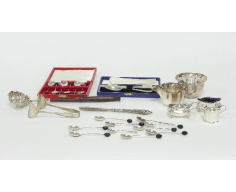 A boxed set of silver teaspoons, Birmingham 1930 with bean terminals, nine silver spoons, silver tongs, a silver butter knife