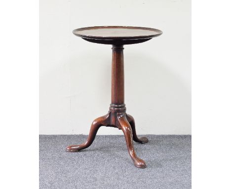 A George III mahogany table, the dished circular top on a turned column and tripod base with pad feet, 45cm diameter