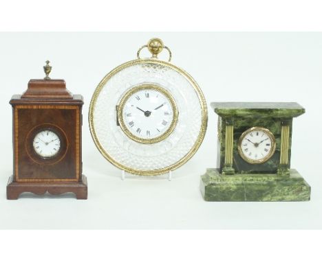 A cartel clock in a glass case, the white enamel dial with Roman numerals, fitted a later battery movement, 20.5cm diameter, 