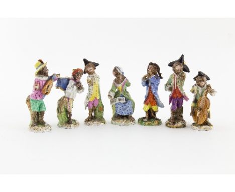 A 19th Century Meissen six-piece monkey band, on gilt scroll bases and a similar monkey band figure, 15cm high and smaller (d