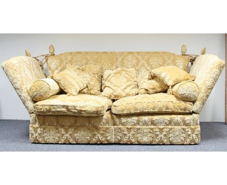 A Knole type sofa covered in gold brocade, fitted a loose seat and back cushions, 254cm wide