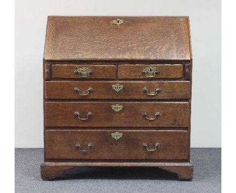 A George III oak bureau, the fall above two short and three long drawers on bracket feet, 92cm wide 