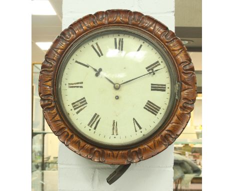 A late 19th Century walnut kitchen dial with carved border, fitted an enamel dial with a single fusée movement, 42cm diameter