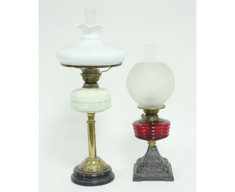 A late 19th Century glass oil lamp with opalescent well and opaque glass shade, 70cm high and another oil lamp, 53cm high Con