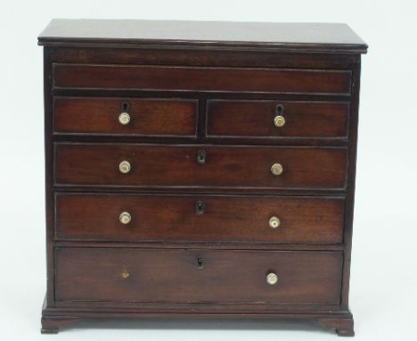 A 19th Century mahogany apprentice chest, fitted a frieze drawer above two short and three long drawers, on ogee bracket feet