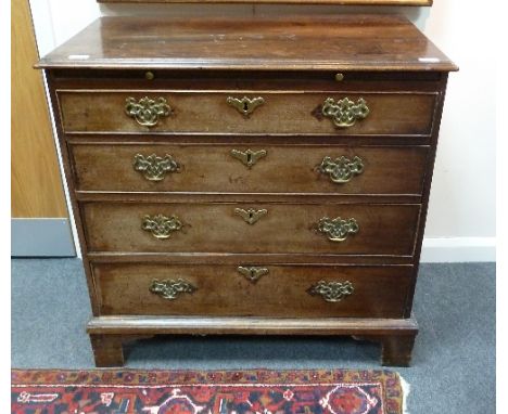 A late 18th Century mahogany chest, the rectangular top with moulded border above a brushing slide and four graduated drawers