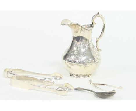 A Victorian silver jug, London 1865, with scroll handle, a pair of sugar nips of wishbone form, a George III caddy spoon and 