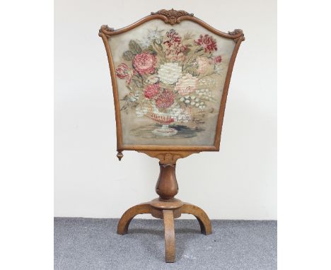 A Victorian oak pole screen with plush work panel on lappet carved stem and tripod base, 114cm high/Provenance: Plas Gwyn, An