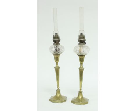 A pair of brass candlestick oil lamps with cut glass wells, 57cm high