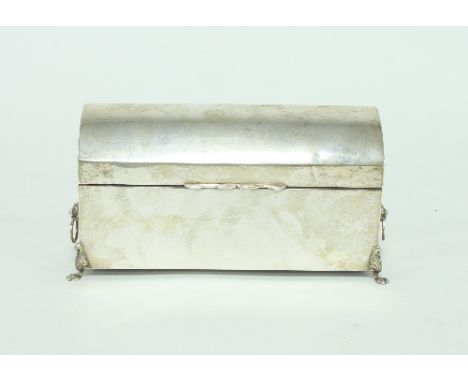 A silver stationery box, Birmingham 1945, with hinged cover and lion mask ring handles to the sides, on paw feet, 20cm wide C