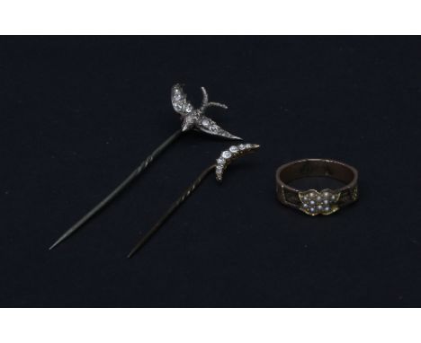 A diamond set pin modelled as a swallow in flight, with ruby set eyes, another diamond pin with seven-stone crescent terminal