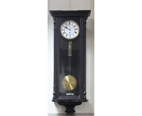 A late 19th Century Vienna regulator wall clock, the ebonised case enclosed by an arch-top glazed door, the brass mounted ena