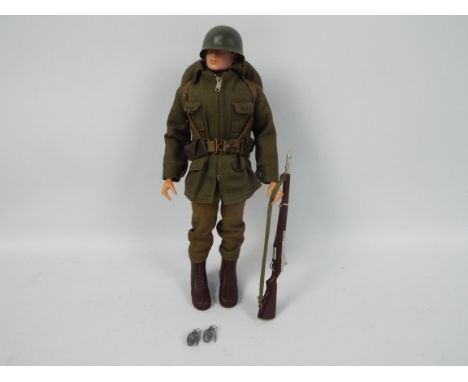 Palitoy, Action Man - A Palitoy Action Man figure in Combat Soldier attire. The black painted hard head figure with gripping 