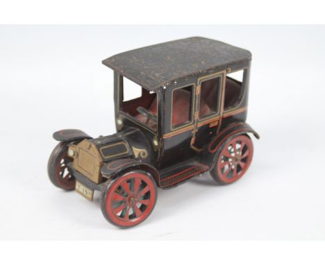 Vintage mechanical tin plate car.  A vintage tin plate car with lever action mechanical mechanism. Approximately 16 cm long x