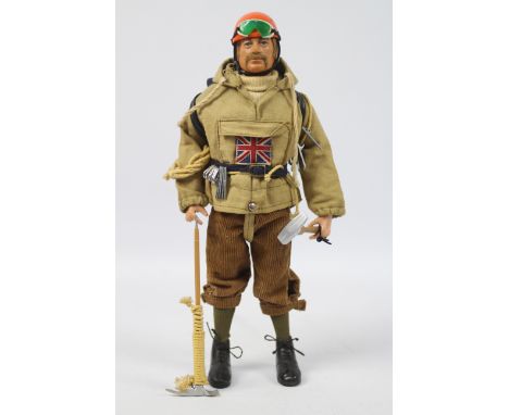 Palitoy, Action Man - A Palitoy blonde flock haired Action Man figure in Mountaineer outfit. The hard hand figure is stamped 