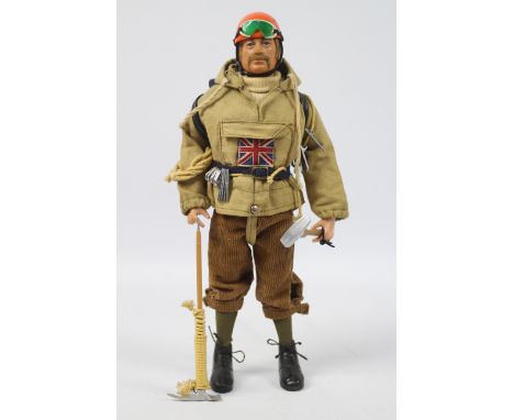 Palitoy, Action Man - A Palitoy blonde flock haired Action Man figure in Mountaineer outfit. The hard hand figure is stamped 