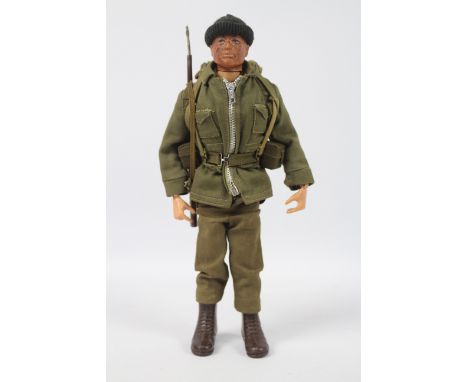 Palitoy, Action Man - A Palitoy dark brown painted hard head Action Man in Combat Soldier outfit, The hard hand figure, with 