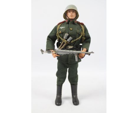 Palitoy, Action Man - A Palitoy blonde painted, hard head Action Man figure in German Stormtrooper outfit. The figure with ha