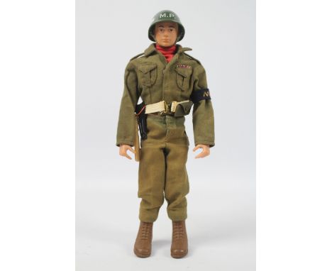 Palitoy, Action Man - A Palitoy blonde painted hard head Action Man in Military Police outfit. The hard hand figure, with fle