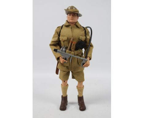 Palitoy, Action Man - A Palitoy dark brown painted, hard head Action Man figure in Australian Jungle Fighter outfit. The figu