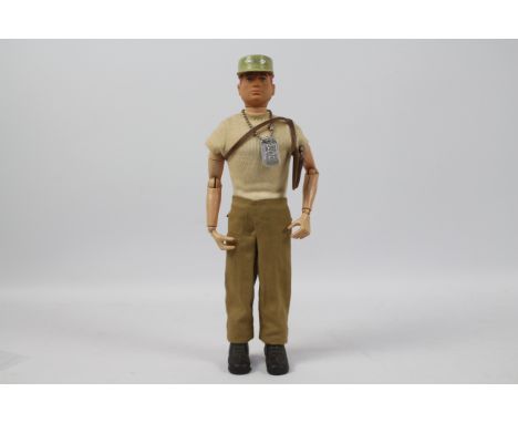 GI Joe, Hasbro - A vintage GI Joe Adventurer figure. The red painted soft head figure is marked 'G.I. JOE ® COPYRIGHT 1964 BY