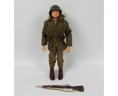 Palitoy, Action Man - A Palitoy Action Man figure in Combat Soldier attire. The red painted hard head figure with gripping ha