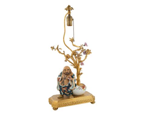 CHINESE GILT BRONZE AND PORCELAIN FIGURAL TABLE LAMPmodelled as a blossoming cherry tree with a flowering finial, a porcelain