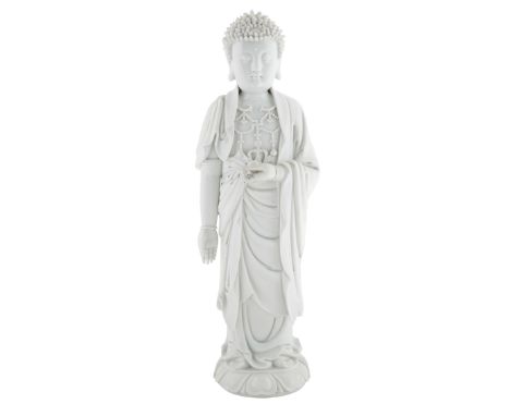 A LARGE CHINESE BLANC DE CHINE FIGURE OF BUDDHA SHAKYAMUNImodelled standing, on a lotus base, Sakyamuni wearing a layered rob