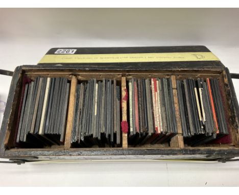 A cased collection of lantern slides including advertising slides, car accidents and more.