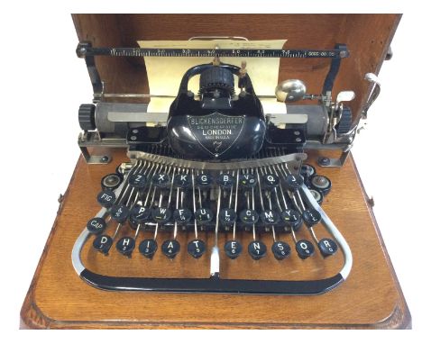 An antique Blickensderfer model 7 typewriter in an oak case. Postage D