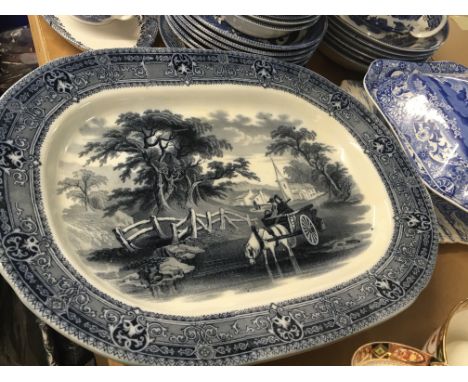 A collection of blue and white ceramics including a Victorian meat plate the centre depicting a horse drawn cart crossing a r