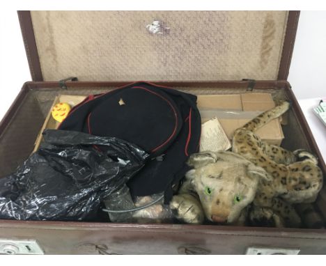 A case containing a Vintage Steiff tiger and small leopard vintage toys and II world war fire ladies hat and other oddments (