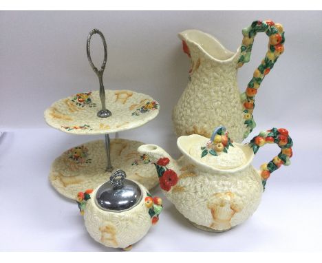 Four Clarice Cliff Harvestware items comprising a large jug, two tier sandwich plate, teapot and a sugar bowl (4). Shipping c