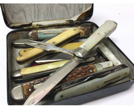 A collection of vintage penknives including a silver hallmarked folding knife and fork