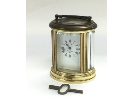 A small brass cased carriage clock with key. Shipping category D.
