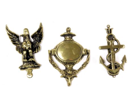 Three brass door knockers, comprising an anchor, Adams style knocker and and eagle.