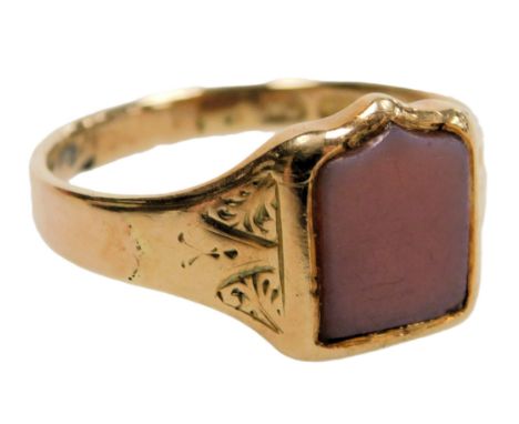 A lady's 12ct gold and sardonyx signet ring, with a shield shaped table, and foliate engraved shoulders, size R, 3.7g. 