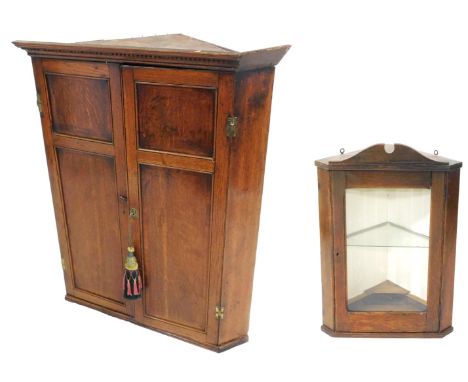 A Georgian oak wall hanging corner cupboard, with a pair of panelled doors, 100cm high, 84cm wide, 55cm, together with a furt