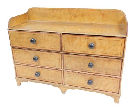 A Regency scumbled pine washstand, with galleried sides and back, above six long drawers, raised on bracket feet, 77cm high, 