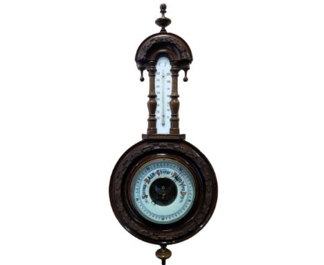 A Victorian oak cased aneroid barometer, with ceramic backed thermometer, the case carved with oak leaves, 71cm high. 